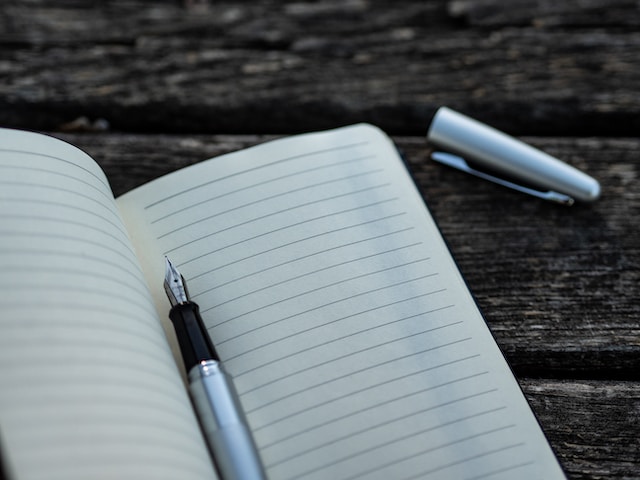 An open notebook and a pen