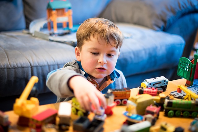 A kid is playing with toys in his bedroom