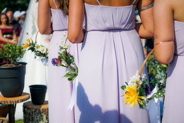 Bridesmaides in Lavender dresses Holding Floral Hoops at an Outdoor Wedding.