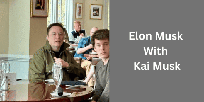 Elon Musk with his triplet son Kai Musk Elon Musk sitting at a restaurant table with his son Kai Musk, both facing the camera.