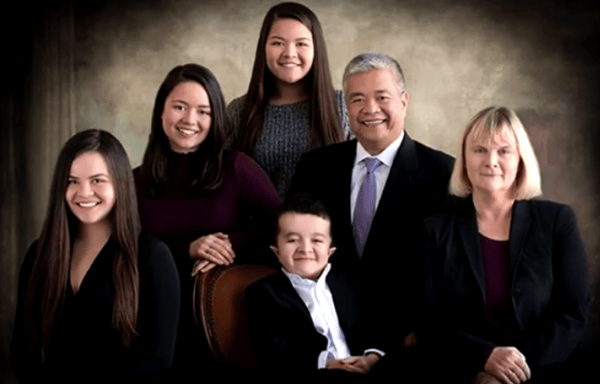 Young Alec Cabacungan with his family members Young Alec Cabacungan is seated in the center of his family, including parents Gil and Alma and three older sisters