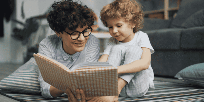 Mother reading a book with her child at home, encouraging bonding and the development of social skills.