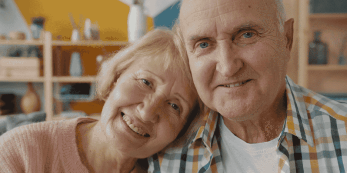 Considering Aged Care Services for Loved Ones Happy elderly couple smiling together at home, symbolizing love, support, and the decision to consider aged care services.