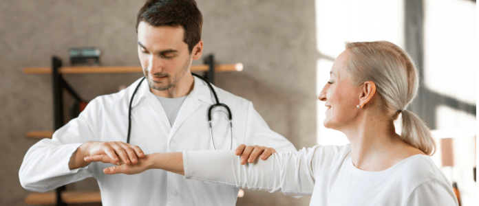 Advancing Wellness Through Rheumatology Doctor examining a patient’s arm during a rheumatology consultation.