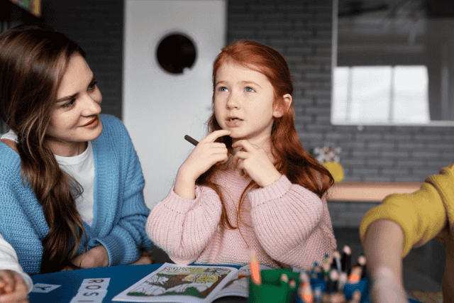 Child Talking With Caregiver During Creative Activity at Home An an Au Pair listening attentively to a child during a conversation