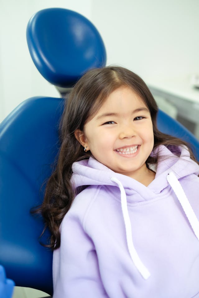 Smiling Child Sitting in Dental Chair