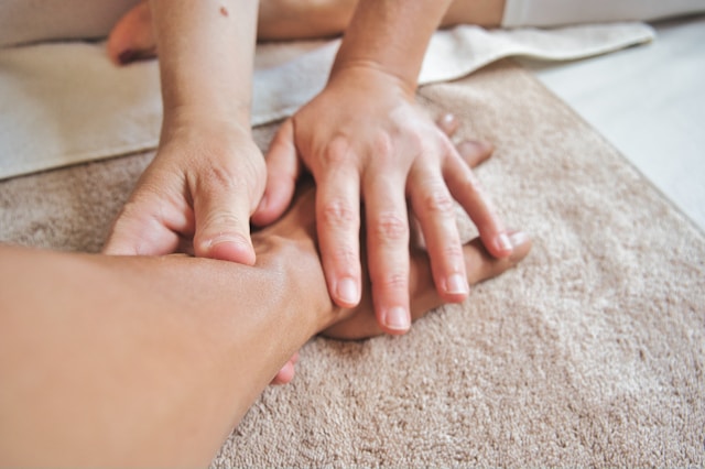 A message therapist is providing service to a customer A message therapist is providing service to a customer
